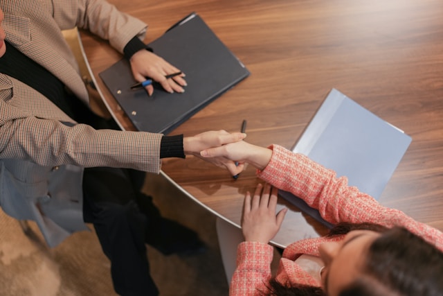 A candidate shaking hands with an EA recruiter
